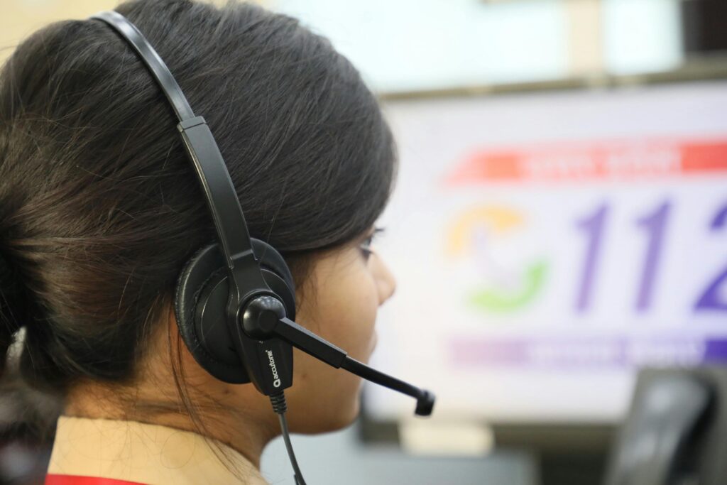 Close-up of a woman wearing a headset at a call center, highlighting customer service.